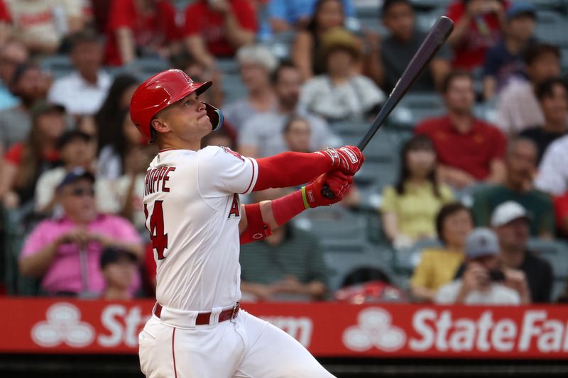 Sep 9, 2023; Anaheim, California, USA;  Los Angeles Angels catcher Logan O'Hoppe (14) hits a two-run home run during the first inning against the Cleveland Guardians at Angel Stadium. Mandatory Credit: Kiyoshi Mio-USA TODAY Sports