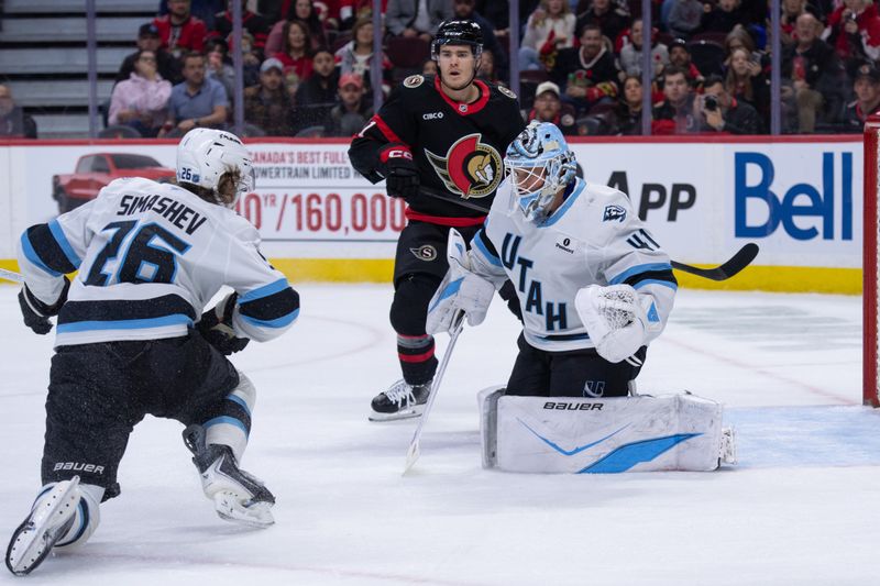 Nov 9, 2025; Ottawa, Ontario, CAN; Utah Mammoth defenseman Dmitri Simashev (26 and Ottawa Senators center Ridly Greig (71) fface each other following a save by Utah Mamoth goalie Vitek Vanacek (41) in the first period at the Canadian Tire Centre. Mandatory Credit: Marc DesRosiers-IMAGN Images