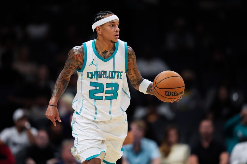 CHARLOTTE, NORTH CAROLINA - OCTOBER 08: Tre Mann #23 of the Charlotte Hornets moves the ball during the first half of the preseason game against the Miami Heat at Spectrum Center on October 08, 2024 in Charlotte, North Carolina. NOTE TO USER: User expressly acknowledges and agrees that, by downloading and or using this photograph, User is consenting to the terms and conditions of the Getty Images License Agreement. (Photo by Grant Halverson/Getty Images)