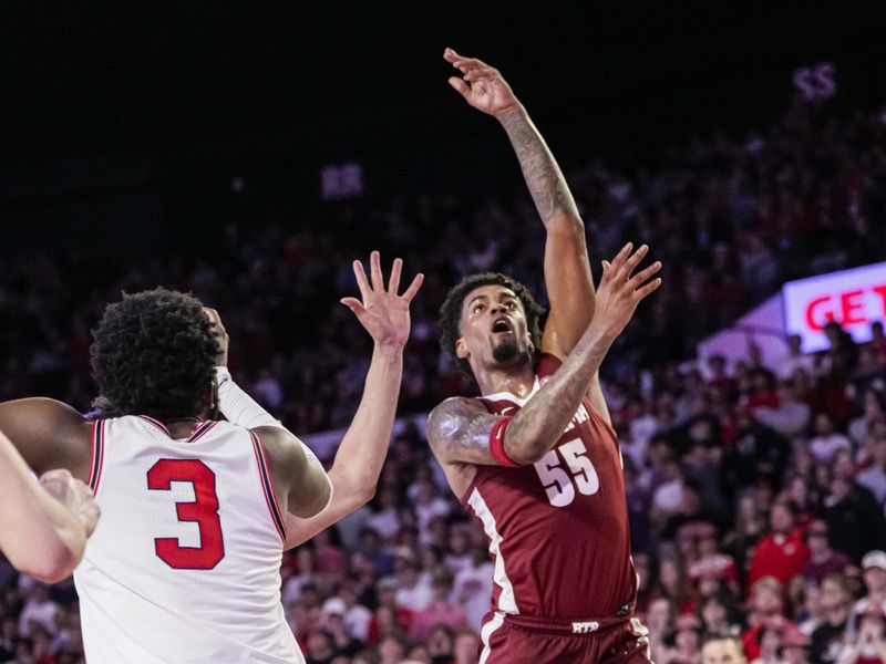 Jan 31, 2024; Athens, Georgia, USA; Alabama Crimson Tide guard Aaron Estrada (55) shoots over Georgia Bulldogs guard Noah Thomasson (3) during the second half at Stegeman Coliseum. Mandatory Credit: Dale Zanine-USA TODAY Sports