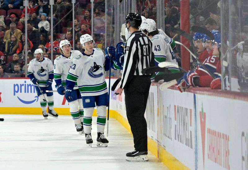 Jan 6, 2025; Montreal, Quebec, CAN; Vancouver Canucks forward Jonathan Lekkerimaki (23) celebrates with teammates after scoring a goal against the Montreal Canadiens during the second period at the Bell Centre. Mandatory Credit: Eric Bolte-Imagn Images