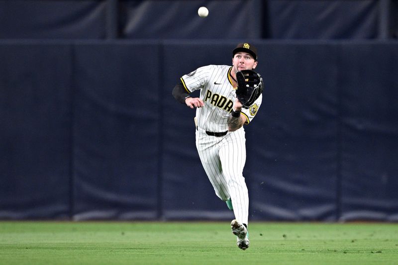 May 13, 2024; San Diego, California, USA; San Diego Padres center fielder Jackson Merrill (3) makes a catch before throwing to second base for a double play during the ninth inning against the Colorado Rockies at Petco Park. Mandatory Credit: Orlando Ramirez-USA TODAY Sports