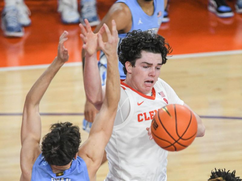 Jan 6, 2024; Clemson, South Carolina, USA; Clemson junior forward Ian Schieffelin (4) and University of North Carolina forward Harrison Ingram (55) look for a rebound during the first half at Littlejohn Coliseum. Mandatory Credit: Ken Ruinard-USA TODAY Sports