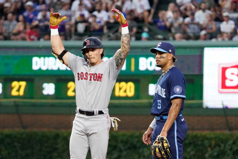 Jul 14, 2023; Chicago, Illinois, USA; Boston Red Sox left fielder Jarren Duran (16) celebrates at second base with a double as Chicago Cubs second baseman Christopher Morel (5) stands nearby during the third inning at Wrigley Field. Mandatory Credit: David Banks-USA TODAY Sports