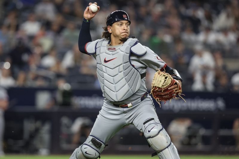 Jun 4, 2025; Bronx, New York, USA;  Cleveland Guardians catcher Bo Naylor (23) attempts to throw a runner out at first base in the seventh inning against the New York Yankees at Yankee Stadium. Mandatory Credit: Wendell Cruz-Imagn Images
