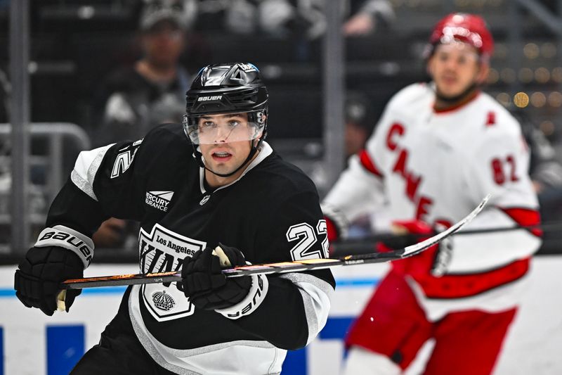 Mar 22, 2025; Los Angeles, California, USA; Los Angeles Kings left wing Kevin Fiala (22) skates against Carolina Hurricanes center Jesperi Kotkaniemi (82) during the first period at Crypto.com Arena. Mandatory Credit: Jonathan Hui-Imagn Images