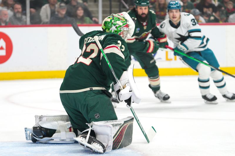 Mar 3, 2024; Saint Paul, Minnesota, USA; Minnesota Wild goaltender Filip Gustavsson (32) makes a glove save against the San Jose Sharks in the first period at Xcel Energy Center. Mandatory Credit: Matt Blewett-USA TODAY Sports