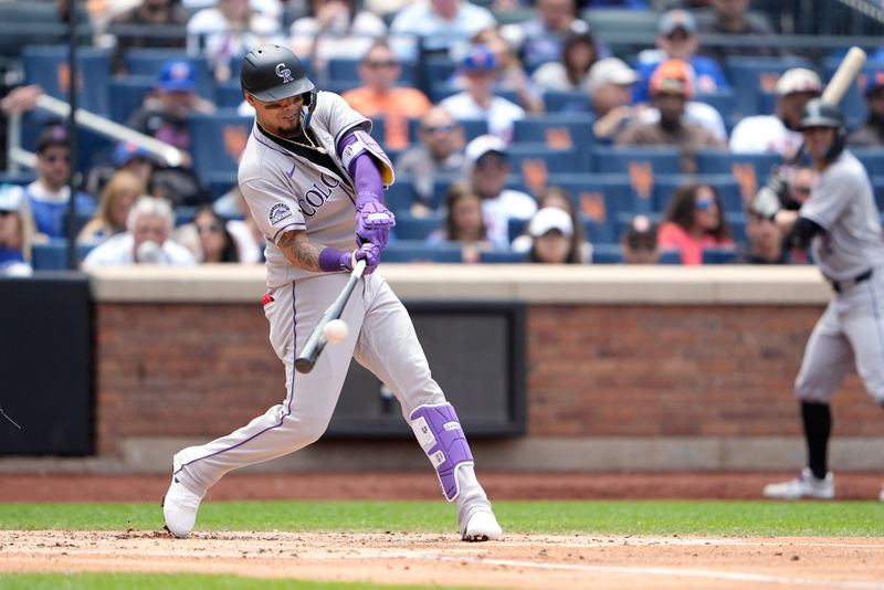 Jun 1, 2025; New York City, New York, USA; Colorado Rockies second baseman Orlando Arcia (8) hits a home run against the New York Mets during the third inning at Citi Field. Mandatory Credit: Gregory Fisher-Imagn Images