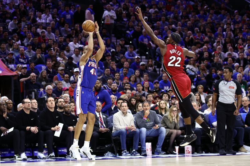 PHILADELPHIA, PENNSYLVANIA - APRIL 17: Nicolas Batum #40 of the Philadelphia 76ers shoots past Jimmy Butler #22 of the Miami Heat during the second quarter of the Eastern Conference Play-In Tournament at the Wells Fargo Center on April 17, 2024 in Philadelphia, Pennsylvania. NOTE TO USER: User expressly acknowledges and agrees that, by downloading and or using this photograph, User is consenting to the terms and conditions of the Getty Images License Agreement. (Photo by Tim Nwachukwu/Getty Images)