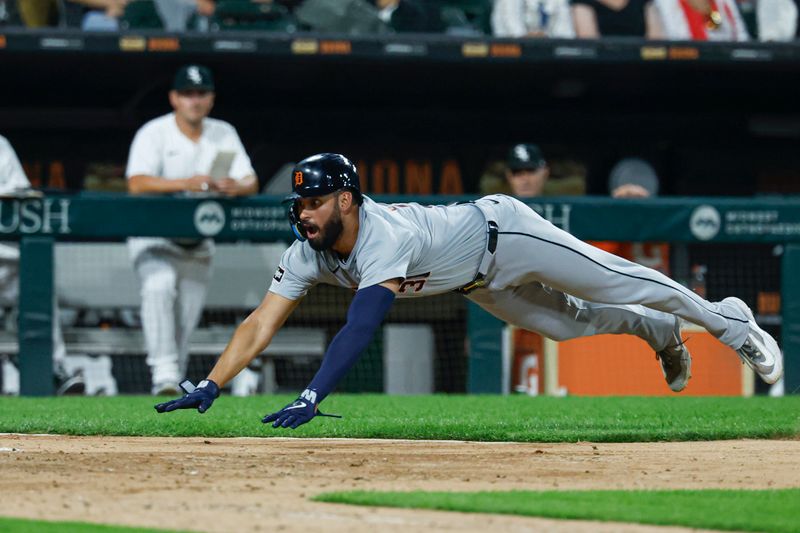 Aug 23, 2024; Chicago, Illinois, USA; Detroit Tigers outfielder Riley Greene (31) dives to score against the Chicago White Sox during the seventh inning at Guaranteed Rate Field. Mandatory Credit: Kamil Krzaczynski-USA TODAY Sports