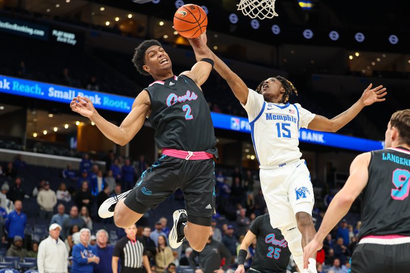 Jan 29, 2026; Memphis, Tennessee, USA; Florida Atlantic Owls guard Isaiah Elohim (2) and Memphis Tigers guard Julius Thedford (15) reach for a rebound during the first half at FedExForum. Mandatory Credit: Wesley Hale-Imagn Images