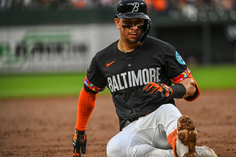 Jul 12, 2024; Baltimore, Maryland, USA;  Baltimore Orioles third baseman Ramón Urías (29) slides for a second inning rbi triple against the New York Yankees at Oriole Park at Camden Yards. Mandatory Credit: Tommy Gilligan-USA TODAY Sports