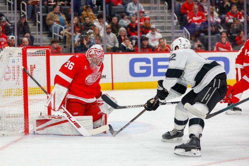 Jan 27, 2026; Detroit, Michigan, USA; Los Angeles Kings defenseman Brandt Clarke (92) takes a shot on Detroit Red Wings goaltender John Gibson (36) during the first period against the Los Angeles Kings at Little Caesars Arena. Mandatory Credit: Brian Bradshaw Sevald-Imagn Images