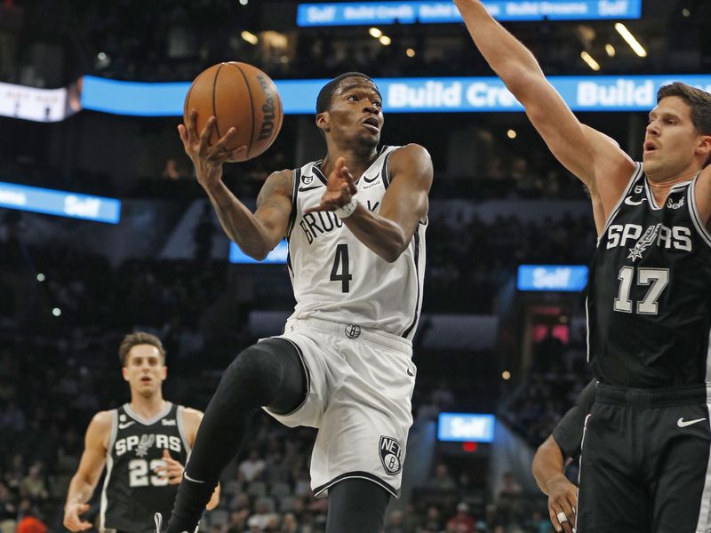 SAN ANTONIO, TX - JANUARY 17:  Edmond Sumner #4 of the Brooklyn Nets shots past Doug McDermott #17 of the San Antonio Spurs in the first half at AT&T Center on January 17, 2023 in San Antonio, Texas. NOTE TO USER: User expressly acknowledges and agrees that, by downloading and or using this photograph, User is consenting to terms and conditions of the Getty Images License Agreement. (Photo by Ronald Cortes/Getty Images)