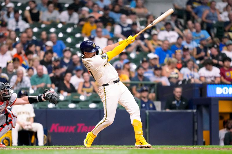 Aug 27, 2024; Milwaukee, Wisconsin, USA;  Milwaukee Brewers shortstop Willy Adames (27) hits a home run during the sixth inning against the San Francisco Giants at American Family Field. Mandatory Credit: Jeff Hanisch-USA TODAY Sports