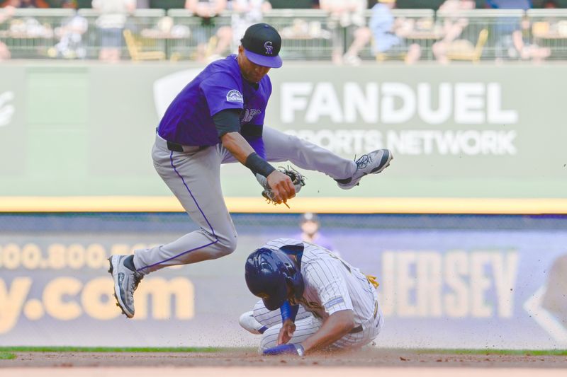 Jun 28, 2025; Milwaukee, Wisconsin, USA; Milwaukee Brewers center fielder Jackson Chourio (11) breaks up a double play attempt by Colorado Rockies shortstop Ryan Ritter (8) in the sixth inning at American Family Field. Mandatory Credit: Benny Sieu-Imagn Images