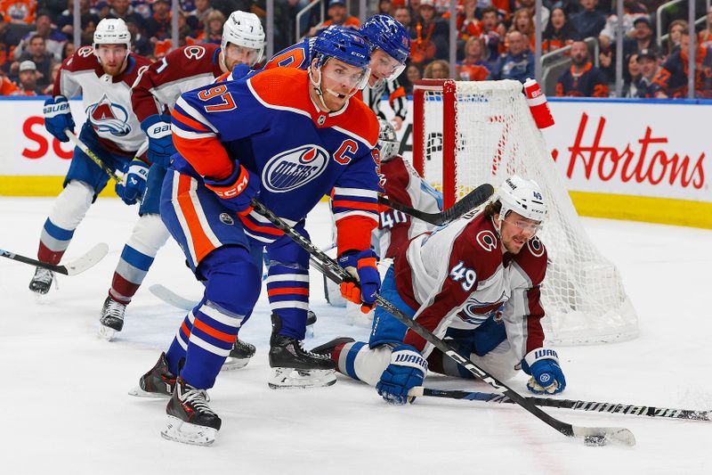 Mar 16, 2024; Edmonton, Alberta, CAN; Edmonton Oilers forward Connor McDavid (97) looks to make a pass in front of Colorado Avalanche defensemen Sam Girard (49) during the first period at Rogers Place. Mandatory Credit: Perry Nelson-USA TODAY Sports