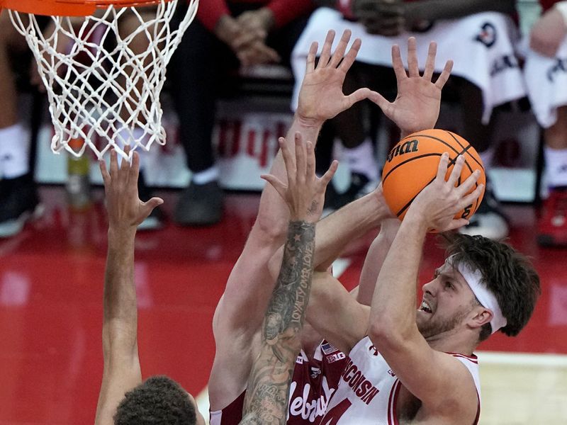 Jan 6, 2024; Madison, Wisconsin, USA; (Editors Notes: Caption Correction) Wisconsin forward Carter Gilmore (14) scores during the first half of their game against Nebraska at Kohl Center. Mandatory Credit: Mark Hoffman-USA TODAY Sports