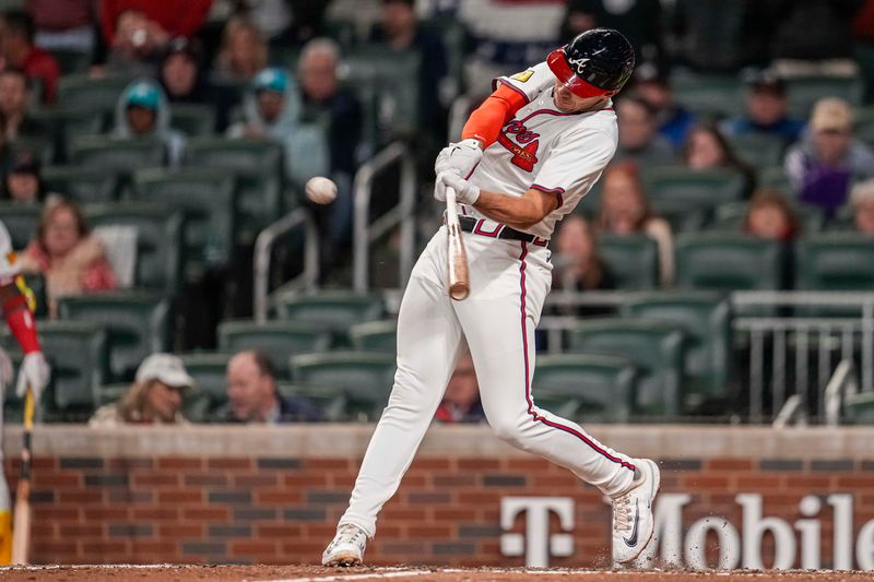 Apr 5, 2024; Cumberland, Georgia, USA; Atlanta Braves first base Matt Olson (28) hits a double to drive in a run against the Arizona Diamondbacks during the ninth inning at Truist Park. Mandatory Credit: Dale Zanine-USA TODAY Sports