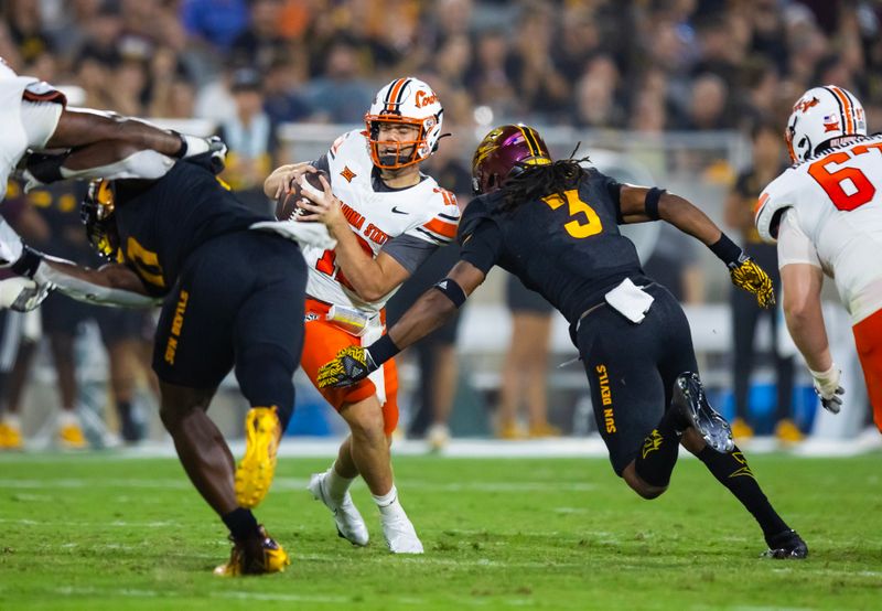 Sep 9, 2023; Tempe, Arizona, USA; Oklahoma State Cowboys quarterback Gunnar Gundy (12) is sacked by Arizona State Sun Devils defensive lineman Clayton Smith (3) in the second half at Mountain America Stadium. Mandatory Credit: Mark J. Rebilas-USA TODAY Sports