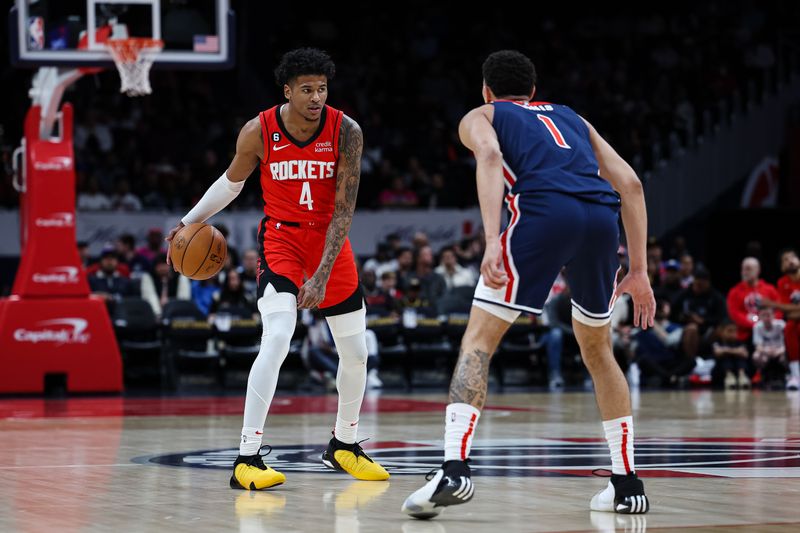 WASHINGTON, DC - APRIL 09: Jalen Green #4 of the Houston Rockets handles the ball as Johnny Davis #1 of the Washington Wizards defends during the first half at Capital One Arena on April 9, 2023 in Washington, DC. NOTE TO USER: User expressly acknowledges and agrees that, by downloading and or using this photograph, User is consenting to the terms and conditions of the Getty Images License Agreement. (Photo by Scott Taetsch/Getty Images)