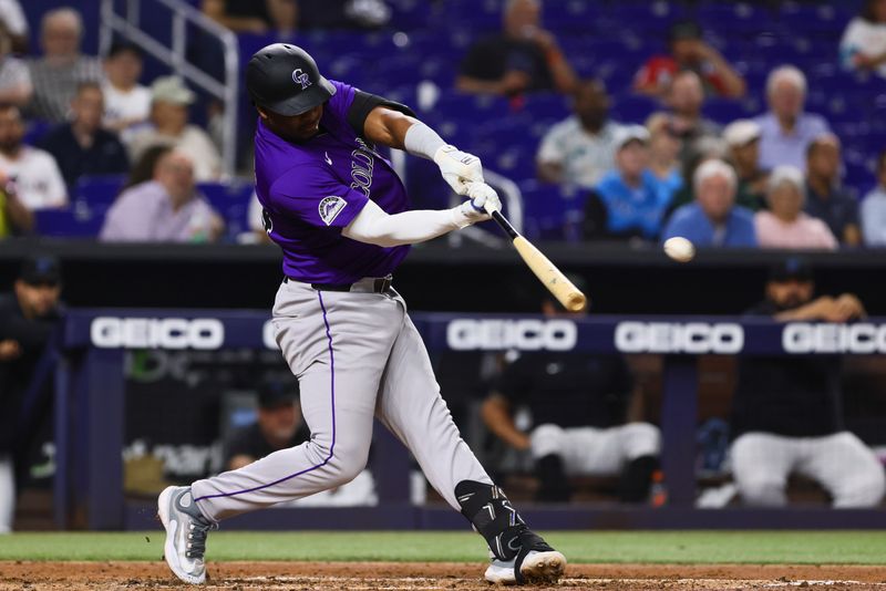 May 1, 2024; Miami, Florida, USA; Colorado Rockies first baseman Elehuris Montero (44) hits a single against the Miami Marlins during the fifth inning at loanDepot Park. Mandatory Credit: Sam Navarro-USA TODAY Sports