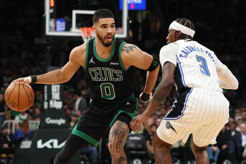 BOSTON, MASSACHUSETTS - APRIL 29: Jayson Tatum #0 of the Boston Celtics drives past Kentavious Caldwell-Pope #3 of the Orlando Magic during the third quarter in Game Five of the Eastern Conference First Round NBA Playoffs at TD Garden on April 29, 2025 in Boston, Massachusetts. NOTE TO USER: User expressly acknowledges and agrees that, by downloading and or using this photograph, User is consenting to the terms and conditions of the Getty Images License Agreement. (Photo by Maddie Meyer/Getty Images)