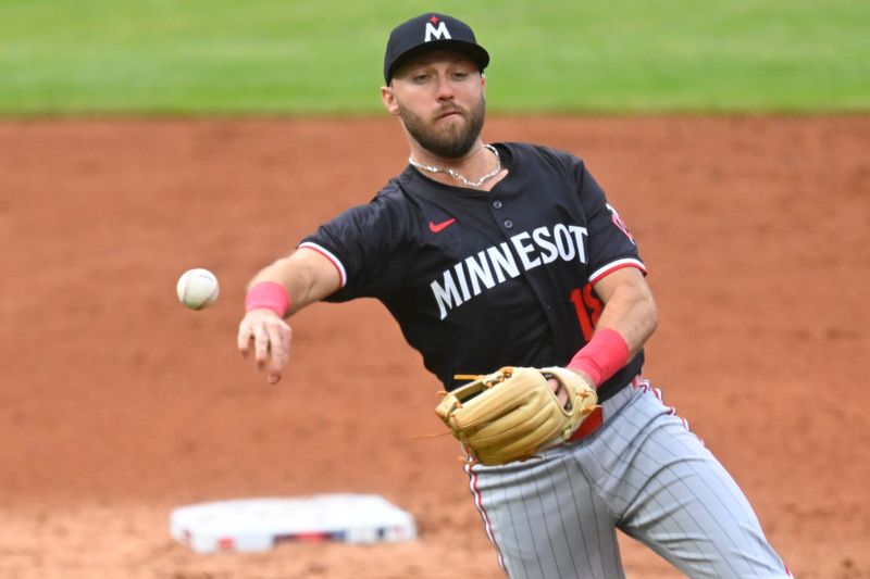 Apr 30, 2025; Cleveland, Ohio, USA; Minnesota Twins second baseman Kody Clemens (18) throws to first base in the third inning against the Cleveland Guardians at Progressive Field. Mandatory Credit: David Richard-Imagn Images