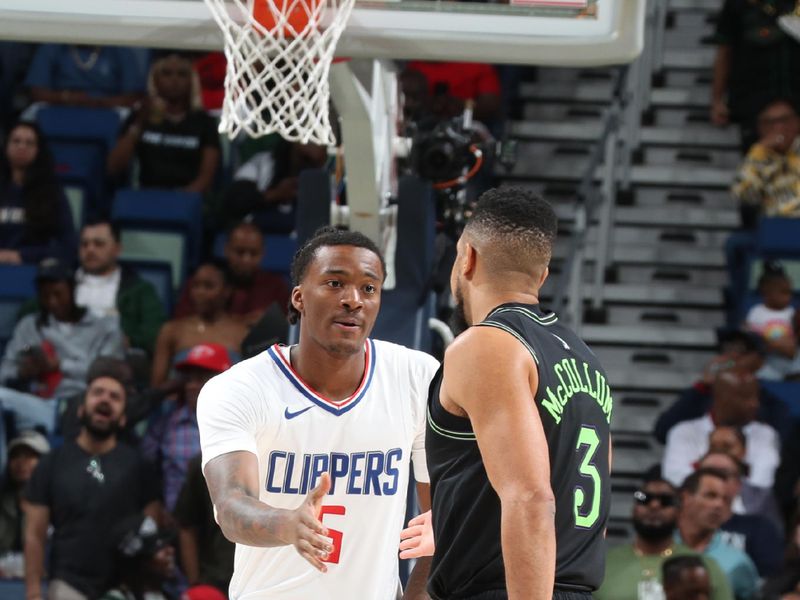 NEW ORLEANS, LA - MARCH 15: Bones Hyland #5 of the LA Clippers shakes hands with CJ McCollum #3 of the New Orleans Pelicans before the game on March 15, 2024 at the Smoothie King Center in New Orleans, Louisiana. NOTE TO USER: User expressly acknowledges and agrees that, by downloading and or using this Photograph, user is consenting to the terms and conditions of the Getty Images License Agreement. Mandatory Copyright Notice: Copyright 2024 NBAE (Photo by Layne Murdoch Jr./NBAE via Getty Images)