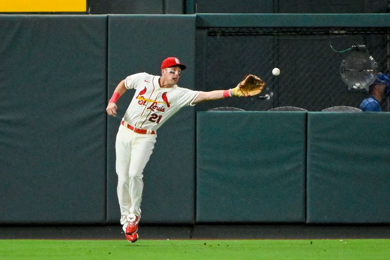 Jul 29, 2023; St. Louis, Missouri, USA;  St. Louis Cardinals left fielder Lars Nootbaar (21) miss plays a single hit by Chicago Cubs right fielder Seiya Suzuki (not pictured) during the eighth inning at Busch Stadium. Mandatory Credit: Jeff Curry-USA TODAY Sports