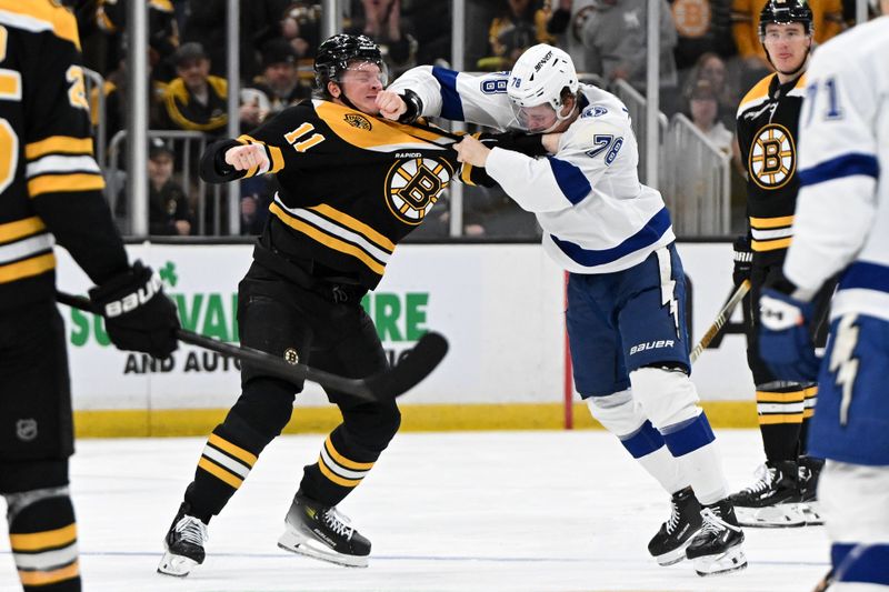 Jan 14, 2025; Boston, Massachusetts, USA; Boston Bruins center Trent Frederic (11) and Tampa Bay Lightning defenseman Emil Lilleberg (78) fight during the second period at the TD Garden. Mandatory Credit: Brian Fluharty-Imagn Images