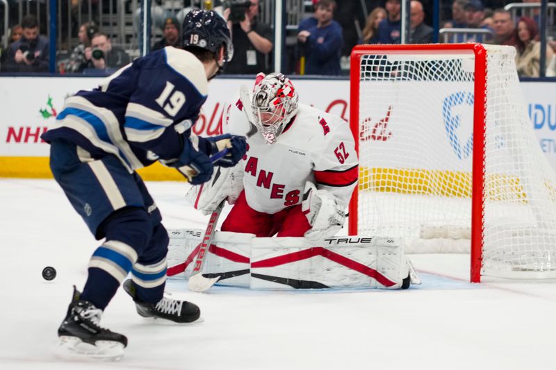 Nov 23, 2024; Columbus, Ohio, USA;  Carolina Hurricanes goaltender Pyotr Kochetkov (52) makes a save in net against Columbus Blue Jackets center Adam Fantilli (19) in the second period at Nationwide Arena. Mandatory Credit: Aaron Doster-Imagn Images