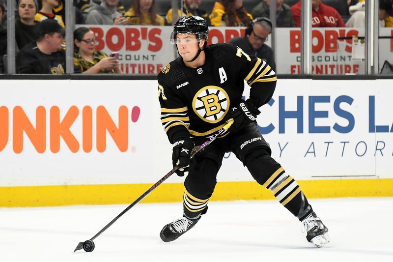 Feb 6, 2024; Boston, Massachusetts, USA; Boston Bruins defenseman Charlie McAvoy (73) controls the puck during the first period against the Calgary Flames at TD Garden. Mandatory Credit: Bob DeChiara-USA TODAY Sports