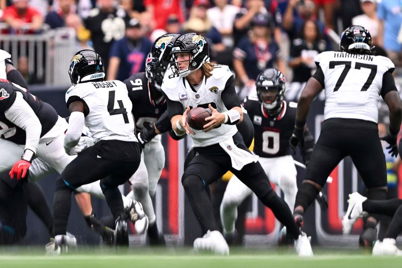 Jacksonville Jaguars quarterback Trevor Lawrence (16) looks to hand off the ball against the Houston Texans in the third quarter during an NFL football game, Sunday, Sept. 29, 2024 in Houston. The Texans defeated the Jaguars 24-20. (AP Photo/Maria Lysaker)