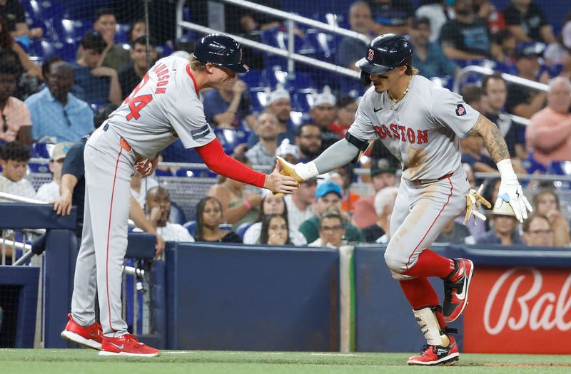 Jul 2, 2024; Miami, Florida, USA; Boston Red Sox left fielder Jarren Duran (16) celebrates his home run with  third base coach Kyle Hudson (84) against the Miami Marlins in the eighth inning at loanDepot Park. Mandatory Credit: Rhona Wise-USA TODAY Sports