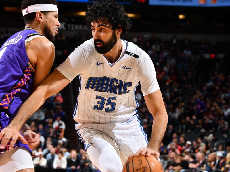 PHOENIX, AZ - NOVEMBER 18: Goga Bitadze #35 of the Orlando Magic drives to the basket during the game against the Phoenix Suns on November 18, 2024 at Footprint Center in Phoenix, Arizona. NOTE TO USER: User expressly acknowledges and agrees that, by downloading and or using this photograph, user is consenting to the terms and conditions of the Getty Images License Agreement. Mandatory Copyright Notice: Copyright 2024 NBAE (Photo by Barry Gossage/NBAE via Getty Images)