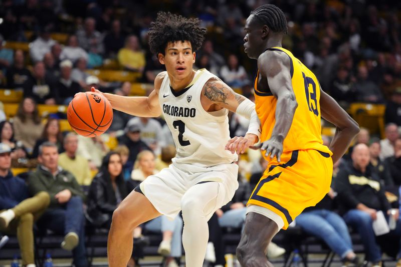 Feb 2, 2023; Boulder, Colorado, USA; Colorado Buffaloes guard KJ Simpson (2) drives at California Golden Bears forward Kuany Kuany (13) in the first half at the CU Events Center. Mandatory Credit: Ron Chenoy-USA TODAY Sports