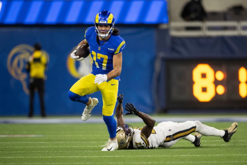 Los Angeles Rams wide receiver Puka Nacua (17) runs with the ball past New Orleans Saints cornerback Isaac Yiadom (27) during an NFL football game, Thursday, Dec. 21, 2023, in Inglewood, Calif. (AP Photo/Kyusung Gong)