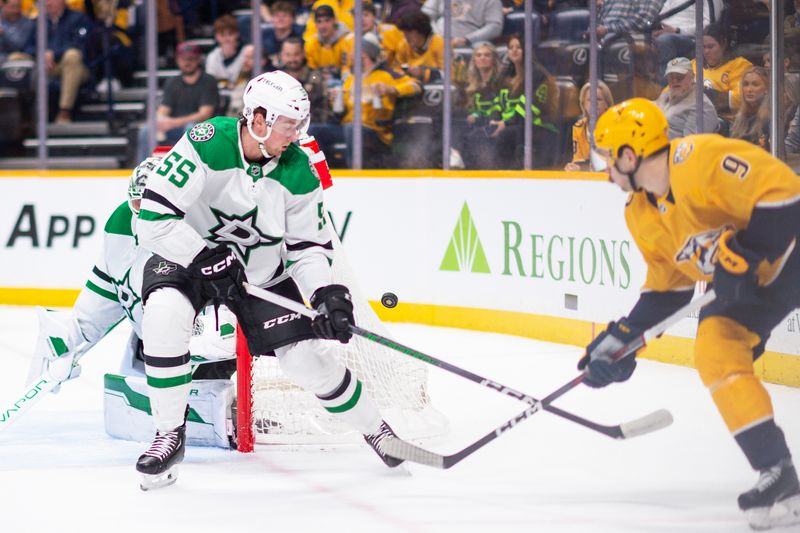 Feb 15, 2024; Nashville, Tennessee, USA; Dallas Stars defenseman Thomas Harley (55) blocks the shot of Nashville Predators left wing Filip Forsberg (9) during the first period at Bridgestone Arena. Mandatory Credit: Steve Roberts-USA TODAY Sports