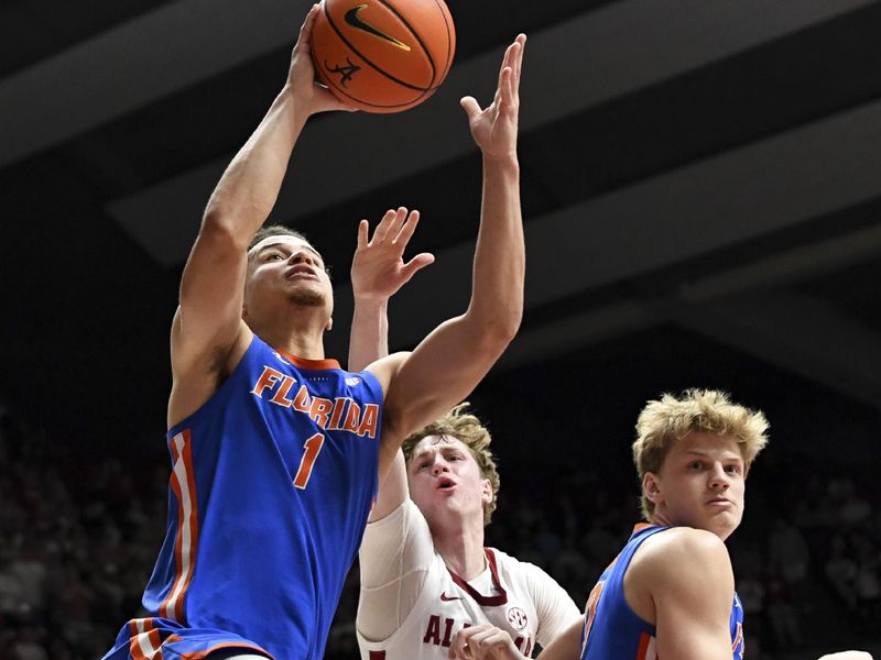 Feb 21, 2024; Tuscaloosa, Alabama, USA; Florida Gators guard Walter Clayton Jr. (1) goes to the basket past Alabama Crimson Tide forward Sam Walters (24) at Coleman Coliseum. Mandatory Credit: Gary Cosby Jr.-USA TODAY Sports