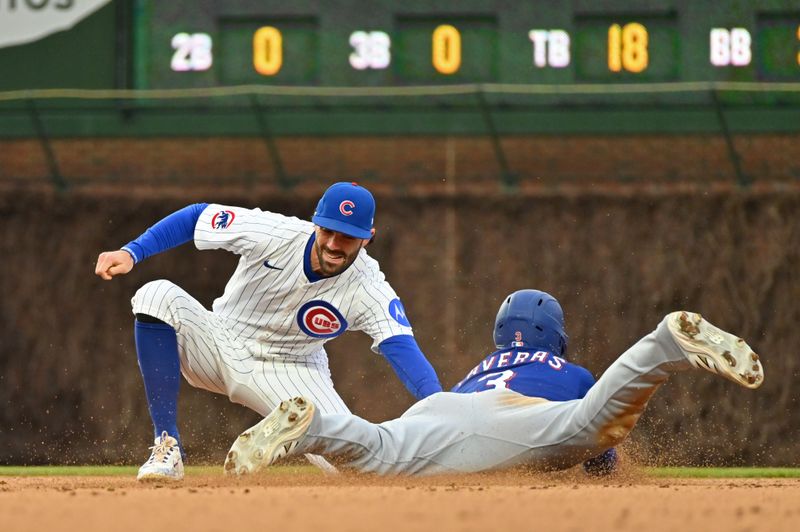 Apr 9, 2025; Chicago, Illinois, USA; Chicago Cubs shortstop Dansby Swanson (7) tags out Texas Rangers center fielder Leody Taveras (3) while attempting to steal during the ninth inning at Wrigley Field. Mandatory Credit: Patrick Gorski-Imagn Images