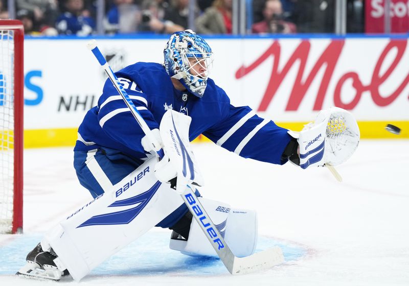 Jan 6, 2026; Toronto, Ontario, CAN; Toronto Maple Leafs goaltender Joseph Woll (60) stops a puck against the Florida Panthers during the second period at Scotiabank Arena. Mandatory Credit: Nick Turchiaro-Imagn Images