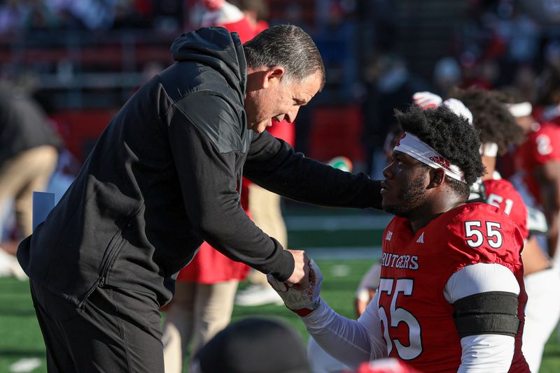 Nov 25, 2023; Piscataway, New Jersey, USA; Rutgers Scarlet Knights head coach Greg Schiano talks with defensive lineman Zaire Angoy (55) before the game against the Maryland Terrapins at SHI Stadium. Mandatory Credit: Vincent Carchietta-USA TODAY Sports