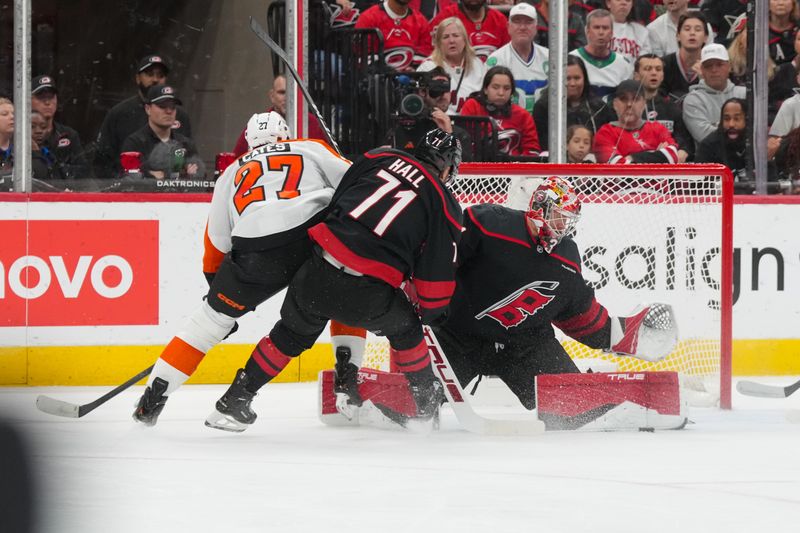 Oct 11, 2025; Raleigh, North Carolina, USA;  Carolina Hurricanes goaltender Frederik Andersen (31) stops the scoring attempt by Philadelphia Flyers left wing Noah Cates (27) during the first period at Lenovo Center. Mandatory Credit: James Guillory-Imagn Images