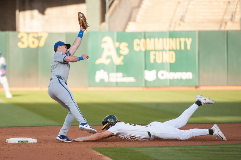 Jun 18, 2024; Oakland, California, USA; Oakland Athletics second base Zack Gelof (20) steals second base during the third inning against the Kansas City Royals  at Oakland-Alameda County Coliseum. Mandatory Credit: Ed Szczepanski-USA TODAY Sports