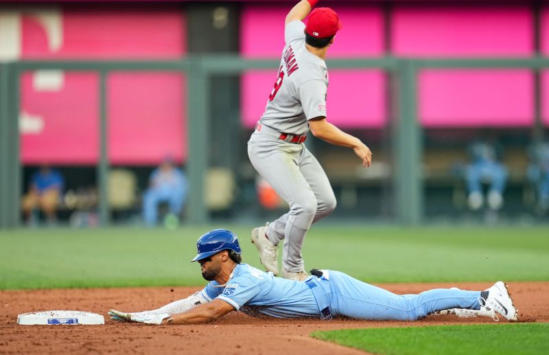 Aug 11, 2023; Kansas City, Missouri, USA; Kansas City Royals left fielder MJ Melendez (1) slides in for a double ahead of the tag by St. Louis Cardinals shortstop Tommy Edman (19) during the first inning at Kauffman Stadium. Mandatory Credit: Jay Biggerstaff-USA TODAY Sports