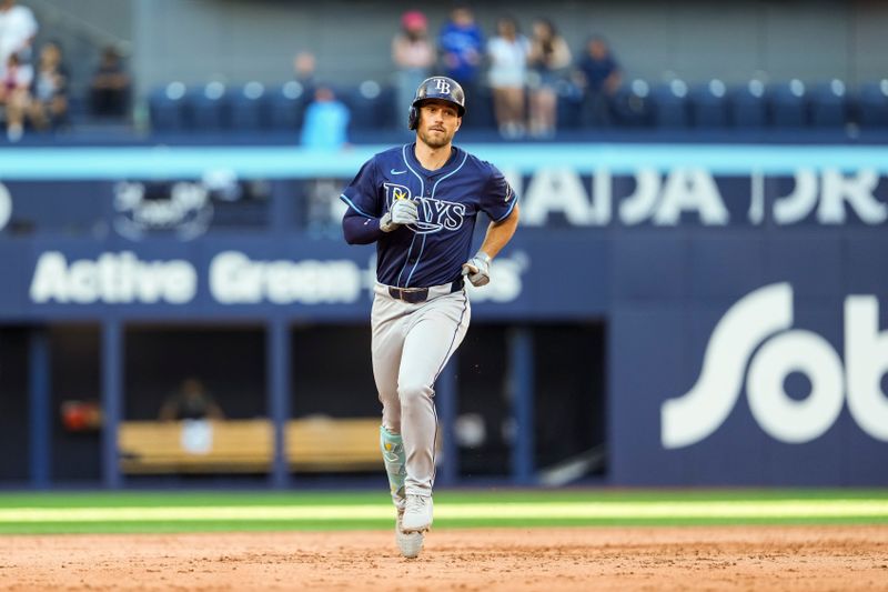 May 15, 2025; Toronto, Ontario, CAN; Tampa Bay Rays second base Brandon Lowe (8) hits a home run against the Toronto Blue Jays during the ninth inning at Rogers Centre. Mandatory Credit: Kevin Sousa-Imagn Images