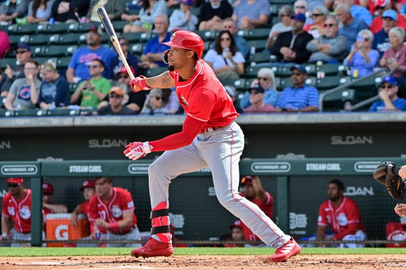Feb 27, 2024; Mesa, Arizona, USA;  Cincinnati Reds right fielder Will Benson (30) triples in the second inning against the Chicago Cubs during a spring training game at Sloan Park. Mandatory Credit: Matt Kartozian-USA TODAY Sports