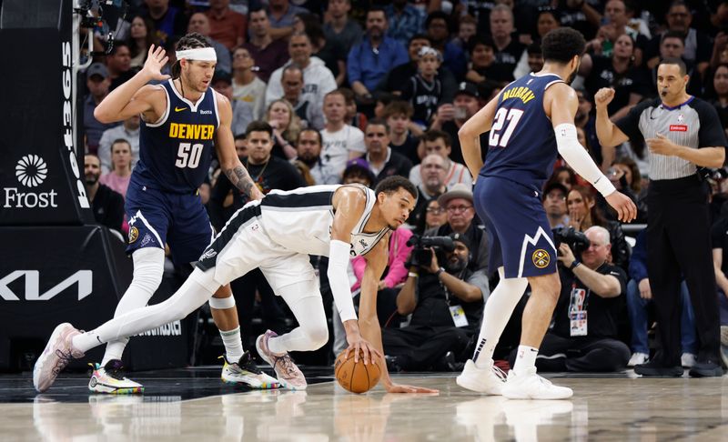 AUSTIN, TX - MARCH 15: Victor Wembanyama #1 of the San Antonio Spurs is fouled by Aaron Gordon #50 of the Denver Nuggets in the second half at Moody Center on March 15, 2024 in Austin, Texas. NOTE TO USER: User expressly acknowledges and agrees that, by downloading and or using this photograph, User is consenting to terms and conditions of the Getty Images License Agreement. (Photo by Ronald Cortes/Getty Images)