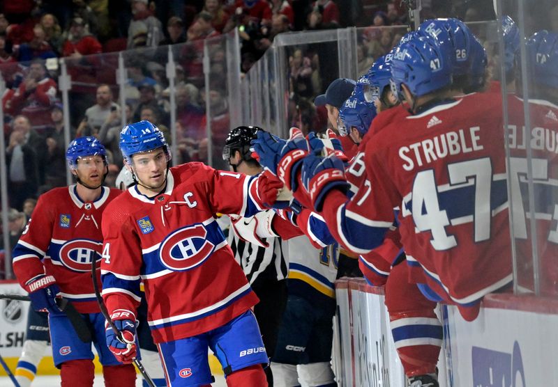 Feb 11, 2024; Montreal, Quebec, CAN; Montreal Canadiens forward Nick Suzuki (14) celebrates with teammates after scoring a goal against the St.Louis Blues during the first period at the Bell Centre. Mandatory Credit: Eric Bolte-USA TODAY Sports